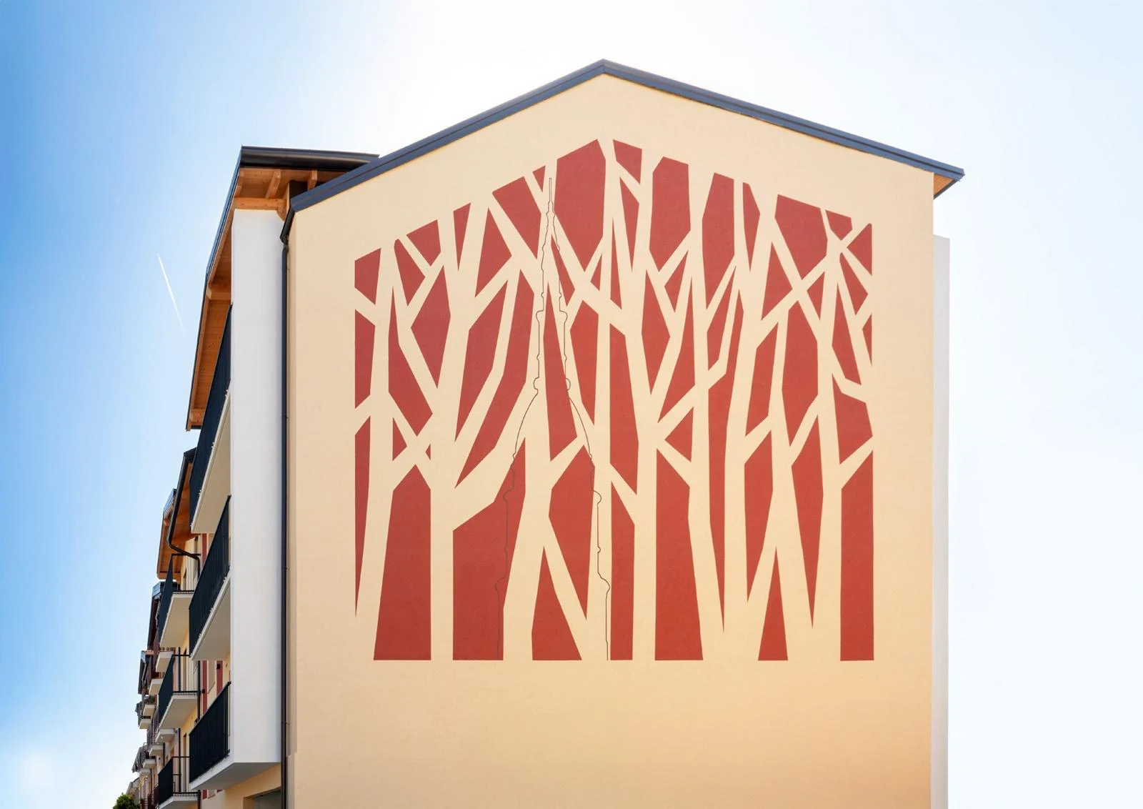 The Giancarlo Green Home facade with its red tree design